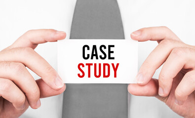 Businessman holding a card with text CASE STUDY ,business concept
