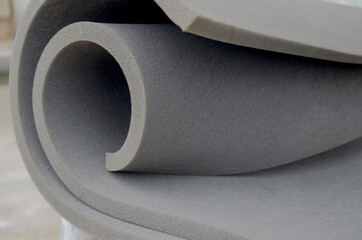 gray sponge foam roll in a spiral style.  foam sponge rubber texture sheet