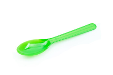 Green plastic spoon isolated on white background.