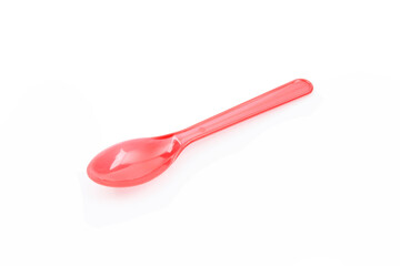 Red plastic spoon isolated on white background.