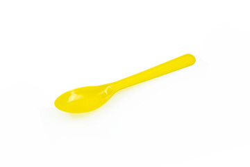 Yellow plastic spoon isolated on white background.