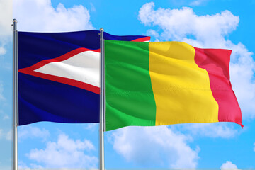 Mali and American Samoa national flag waving in the windy deep blue sky. Diplomacy and international relations concept.