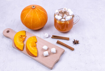 pumpkin cocktail with spices and marshmallows on a light  background copy space