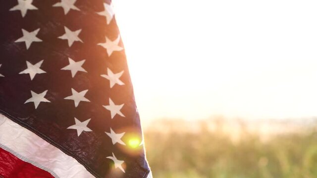 Close up American flag waving on sunset with soft focus, Slow Motion. Concept of Memorial Day or 4th of July, Independence Day, Veterans Day, Celebrate USA, American Election. American Concept.