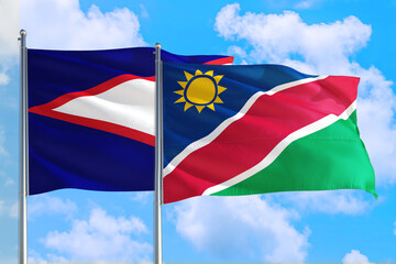 Namibia and American Samoa national flag waving in the windy deep blue sky. Diplomacy and international relations concept.