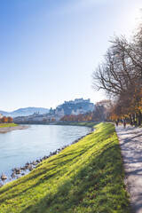 Fototapeta na wymiar European city trip: Salzburg old city and river salzach in autumn, colorful sunshine, Austria