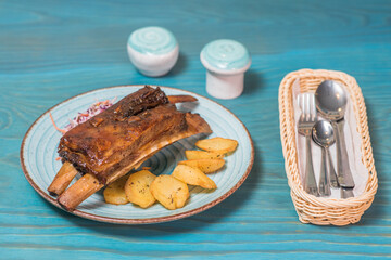 Delicious and hearty texas ribs with homemade potatoes and salad