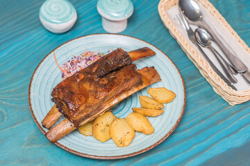 Delicious and hearty texas ribs with homemade potatoes and salad