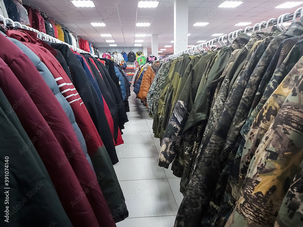 Wall mural rows of warm men's jackets in the store on sale