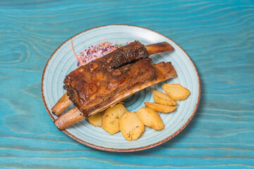 Delicious and hearty texas ribs with homemade potatoes and salad