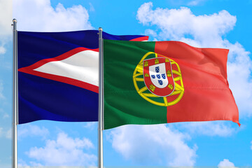 Portugal and American Samoa national flag waving in the windy deep blue sky. Diplomacy and international relations concept.