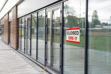 Sorry we're closed sign. grunge image hanging on a dirty glass door