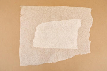 Obraz premium White plastic foam sheet pieces on cardboard background. Closeup of torn foam polyethylene pieces.