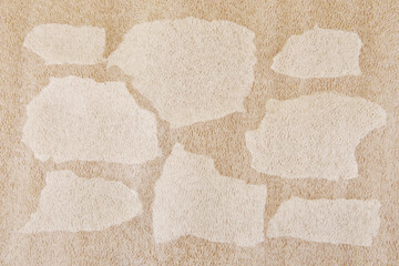 White plastic foam sheet pieces on cardboard background. Closeup of torn foam polyethylene pieces.