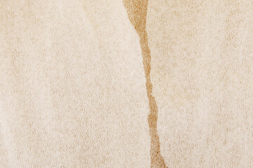 White plastic foam sheet pieces on cardboard background. Closeup of torn foam polyethylene pieces.