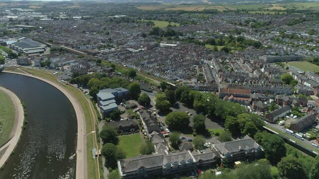 Aerial of a passenger train moving through a city landscape