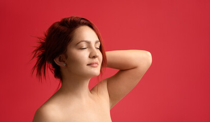 Obraz premium Redheaded young woman with beautiful clean skin and no make-up. Woman skin care