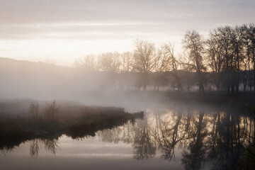 Fototapeta na wymiar Autumn landscape fog over river and sky with rising sun