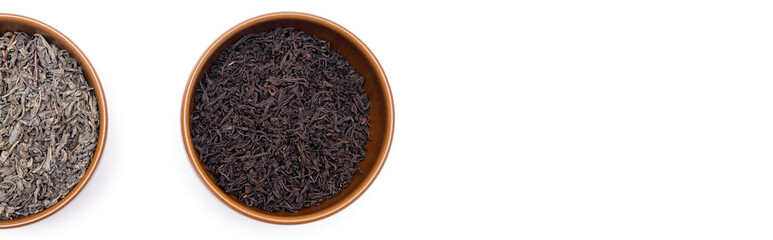 Green and black tea leaves in brown plates. Place for text. Copy space. Banner
