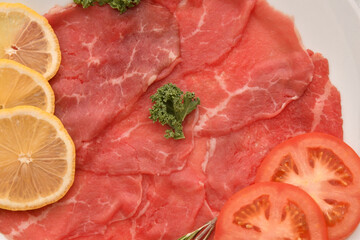 Carpaccio dish of thinly sliced pieces (slices) raw beef tenderloin 