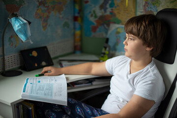 pensive boy teaches homework due to coronavirus