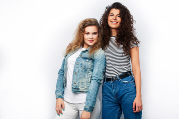 Fototapeta premium young pretty teenage girls friends with blond and brunette curly hairs posing cheerful isolated on white background, lifestyle people concept