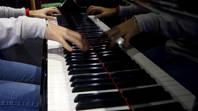 Professional pianist. The pianist performs playing a grand piano. Hands close up.
