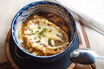 Bowl of traditional french onion soup close-up