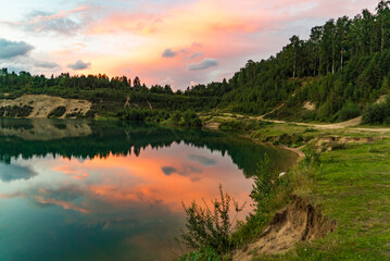 Picturesque sunset over the lake with a mirror image . Leningrad region.