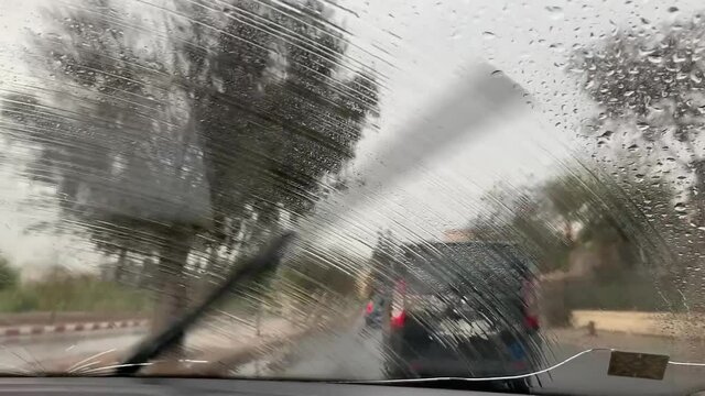 car wipers cleaning the windshield during a rainy day