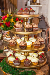 Wedding cake of cupcakes with flowers at reception