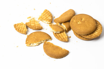 Fototapeta na wymiar Scattered broken biscuits isolated on white background