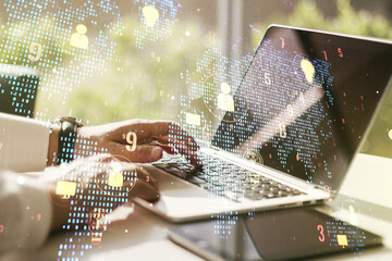 Double exposure of social network icons concept with world map and hand typing on computer keyboard...
