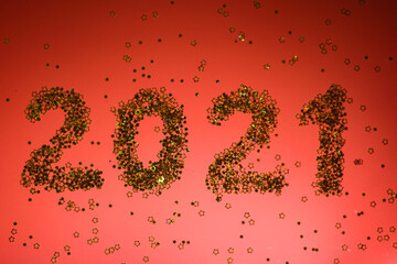 2021 numbers. Golden glitters. Red background. New Year wallpaper