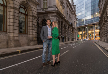 Young flirty couple posing on a street of City in London, UK