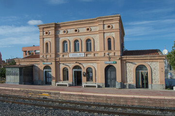 Obraz premium train station In Torrijos, in Toledo. Spain in the photograph appear the posters written in Spanish with the left destination Caceres. right destination Madrid. waiting room and circulation cabinet