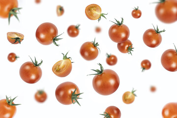 Red tomatoes levitate on a white background.Vegetables fall.