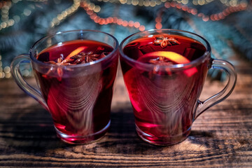 Christmas mulled red wine with and ingredients on a wooden brown table. Traditional hot drink at...