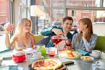 happy young caucasian friends gathering in cafe, sitting at table, chatting, talking.they are spending funny time, students or best friends meeting