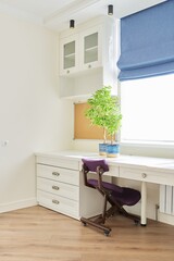 Orthopedic knee chair in the interior of children's room, home office