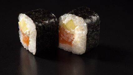 sushi maki two pieces with salmon, cucumber and cheese © DmitLVStock