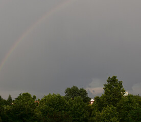 A rainbow appeared across the gray and cloudy sky