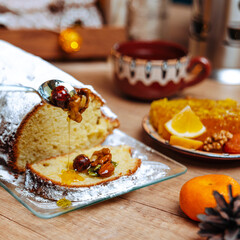 homemade pie. homemade cake with nuts and raisins. honey dripping from spoon. christmas table setting. cozy and warm. 