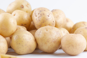 New raw potatoes isolated on white background close up