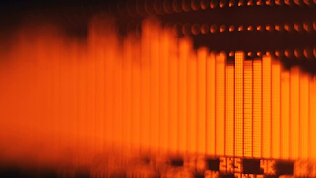 The professional concert equalizer has a yellow spectrum analyzer on the display that analyzes the frequency range of music or any sound and can change it. Closeup