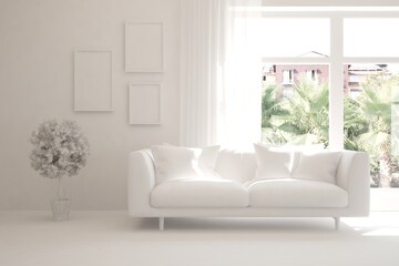 Fototapeta premium White living room with sofa and summer landscape in window. Scandinavian interior design. 3D illustration