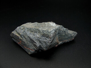 Sample of raw gray magnetite on a black background