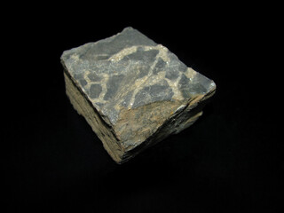 Sample of raw mineral siderite on a black background