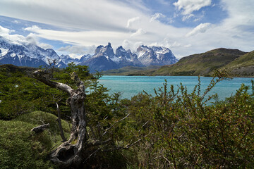Cuernos, Horns of torres del paine covered with snow,  torres del paine national park in the Andes, southern Chile, south America, towering over the turquoise water of lake Pehoe with dramatic clouds