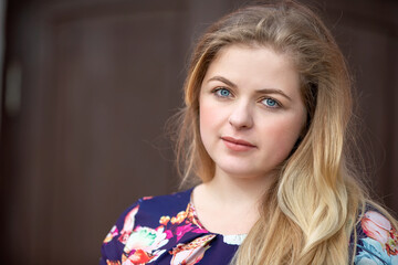Fototapeta premium Portrait of a blonde girl with blue eyes. A girl with a European style face.